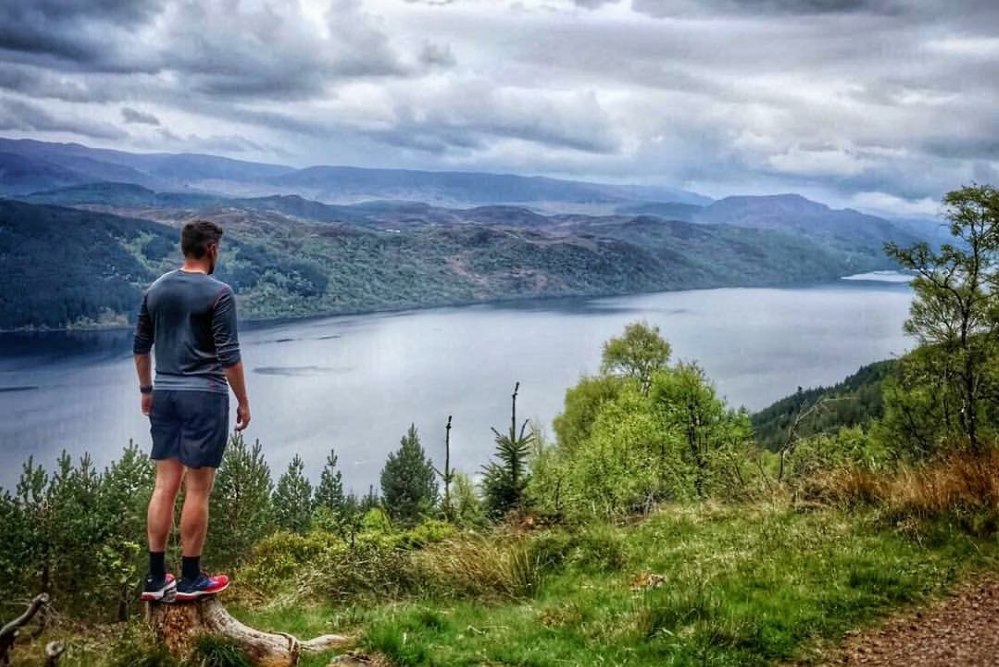 Hiker on the Great Glen Way overlooking Loch Ness Hiker on the Great Glen Way looking over Loch Ness in the Scottish Highlands