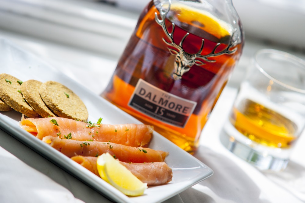 A plate of food and a bottle of whisky at the Glenmoriston Arms Hotel