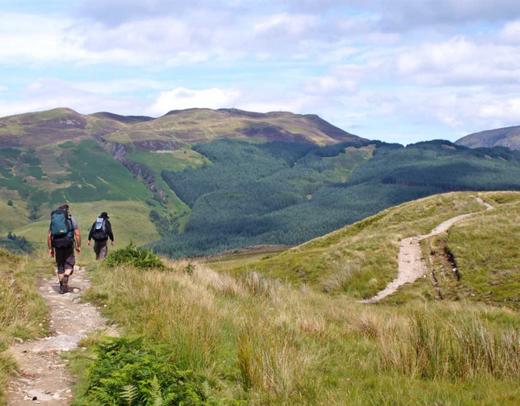 Hikers along the West Highland Way on a sunny day.