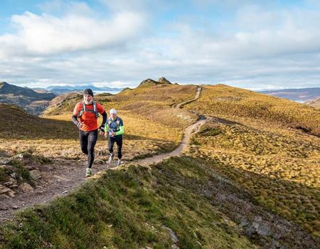 two people running in the highlands