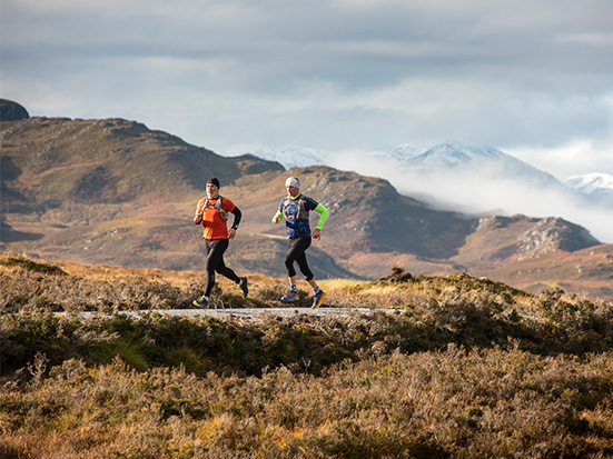 running men in the Highlands of Scotland
