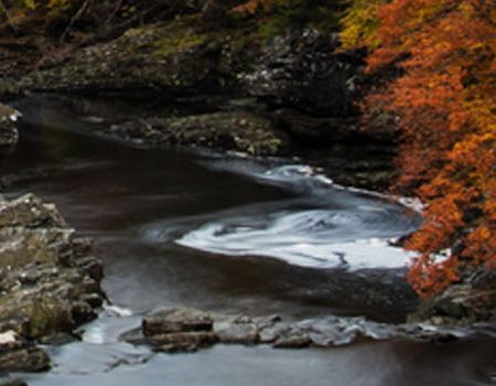 The Great Glen Way with Autumnal colours encompassing a river