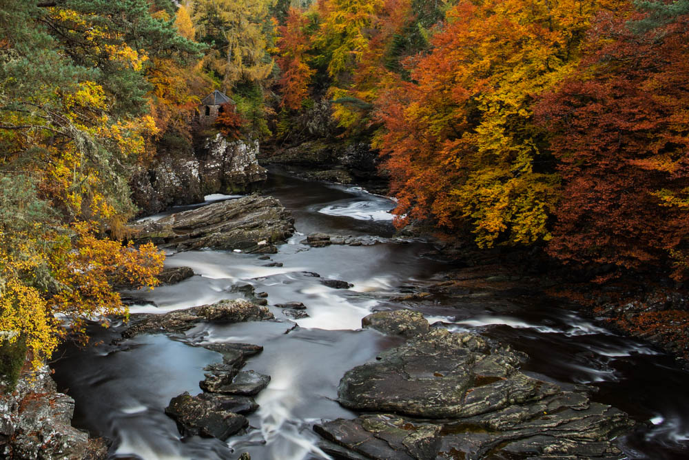 The River Moriston surrounded br Autumnal trees on the Great Glen Way