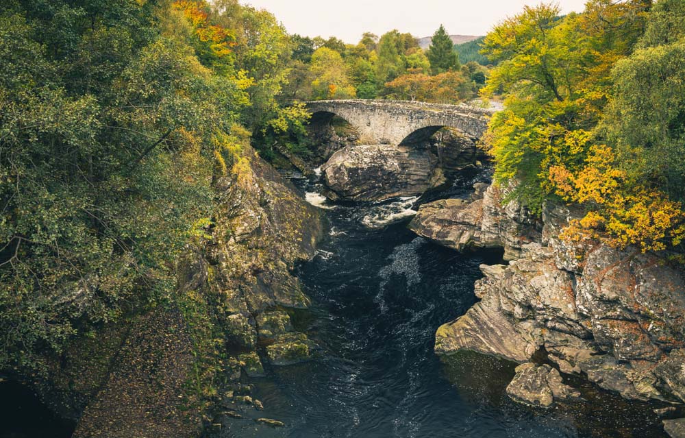 Invermoriston Thomas Telford bridge surrounded by Autumnal tress