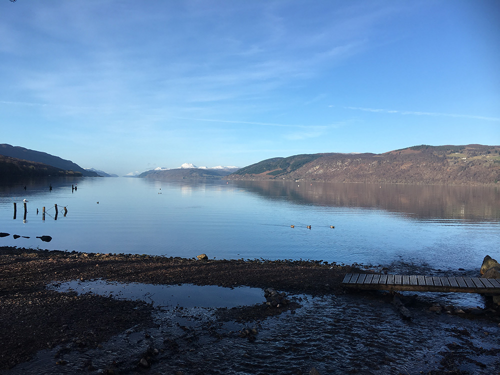 Dores beach on a winters day with snowy mountains in the background