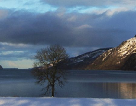 Snowy mountains cocooning Loch Ness